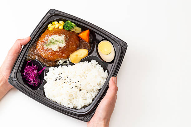 istock Hand holding a Japanese-style hamburger bento 2219713339
