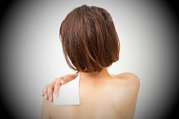 A woman with a compress on her shoulder.