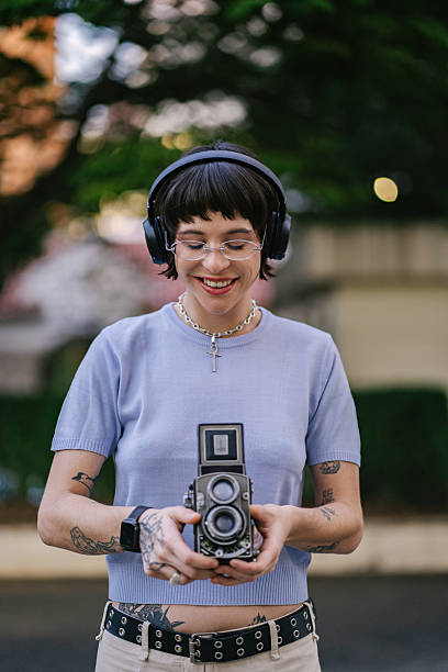 istock Young woman taking pictures with analog camera 2219713624