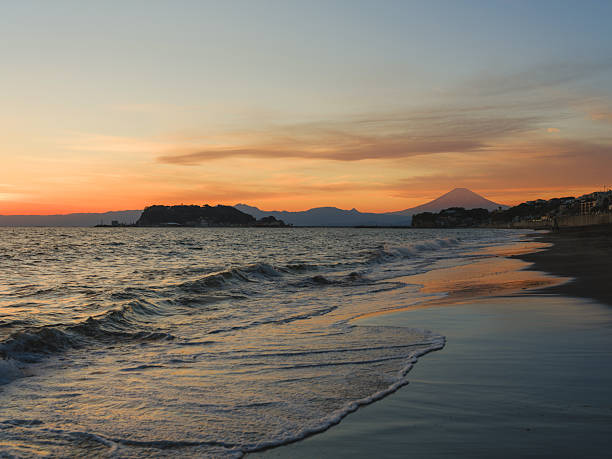 Fuji mountain visible at seaside in Kamakura, Japan at vibrant sunset