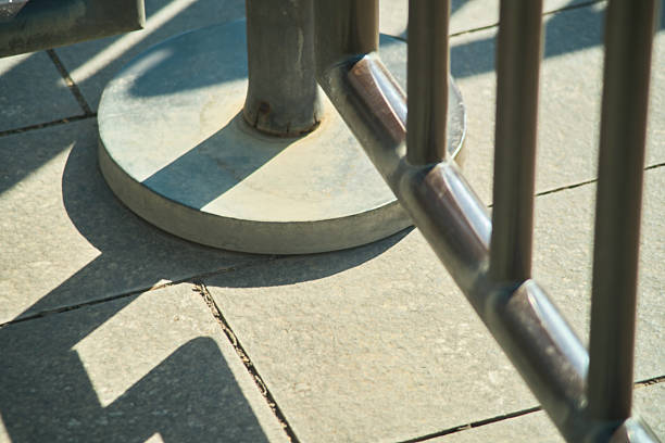 Metallic Bike Rack Base and Ground Details Under Sunlight