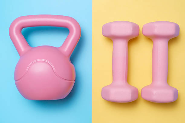 istock Kettlebell and dumbbells on blue and yellow background close-up top view. 2219721018