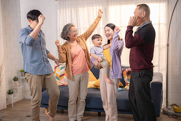 istock Family enjoys a joyful gathering at home while dancing and celebrating together during a sunny afternoon 2219725389