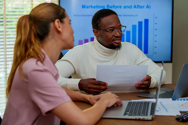 istock In modern business setting, two professionals engage discussion about technology and marketing strategies, analyzing data related to AI impact marketing. Their collaboration highlights importance 2219725483