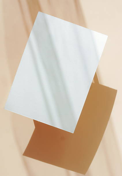 istock Card mockup empty blank paper and sunlight shadow on beige background top view . Copy space. 2219728515