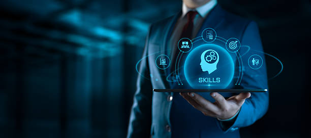 istock Businessman holding tablet with Skills icons on screen - Education and E-Learning Concept 2219729531