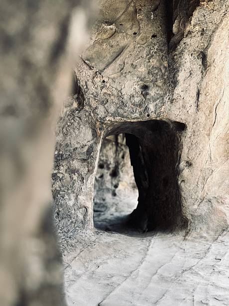 View through a dark stone tunnel in Uplistsikhe, Georgia’s ancient cave town, representing mystery and history.