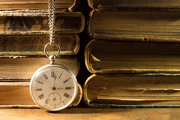 istock Antique pocket watch with old books. Still life 2219731734