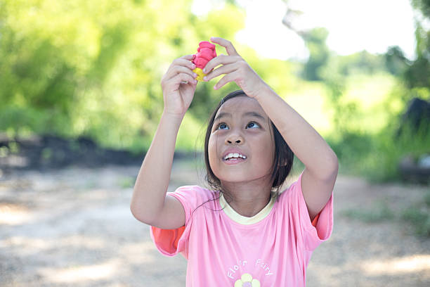 Cute little girl playing in the park in summer