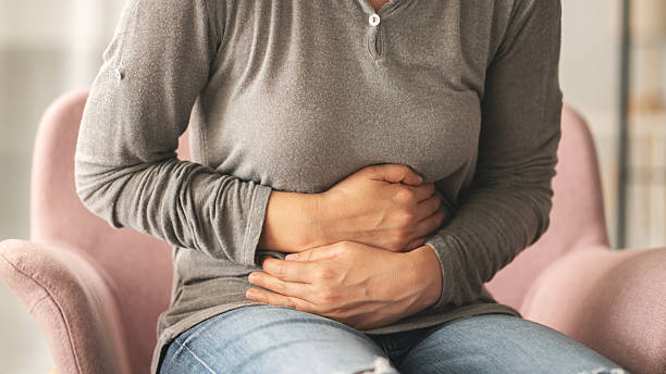 istock Young woman with stomach ache 2219733706