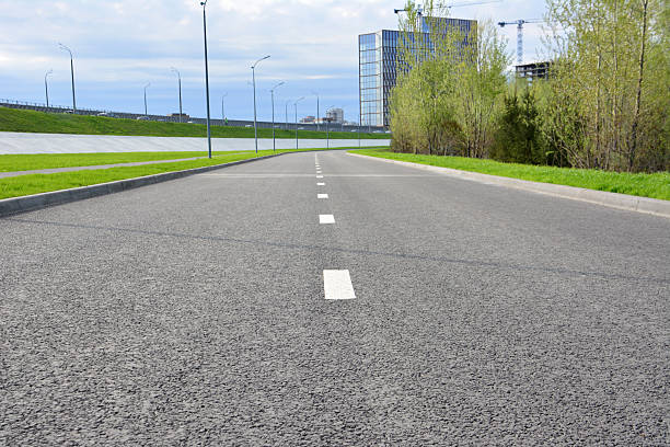 istock An empty asphalt road with white lines, under a cloudy sky 2219736272