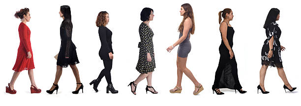 group of women in profile walking with elegant dress and high shoes on white background,