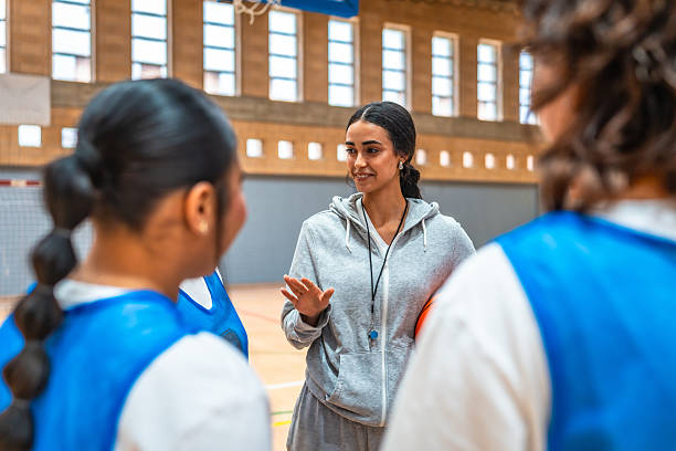 istock Female basketball coach explaining game strategy to her team 2219738316