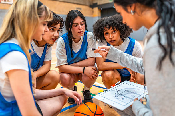 istock Female basketball coach explaining game strategy to her team 2219738363