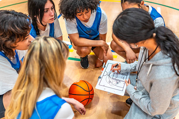 istock Female basketball coach explaining game strategy to team 2219738377