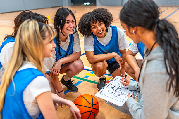 istock Female basketball coach explaining game strategy to team 2219738378