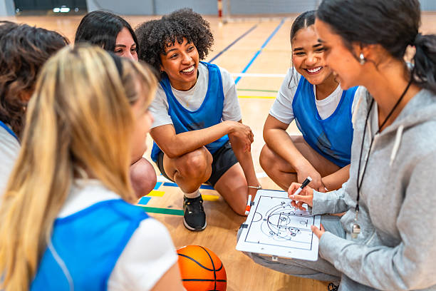 istock Female basketball coach explaining game strategy to her team 2219738391