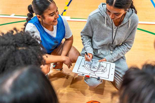 istock Female basketball coach explains game strategy to her team 2219738395