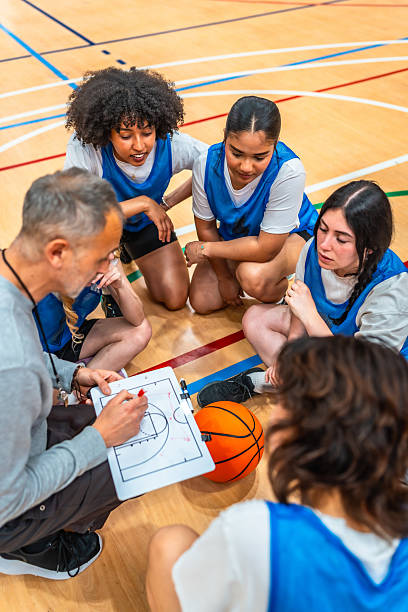 istock Basketball coach explaining game strategy to female team players 2219738451