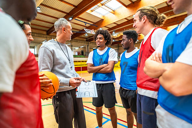 istock Basketball coach explaining strategy to his team in the court 2219738538