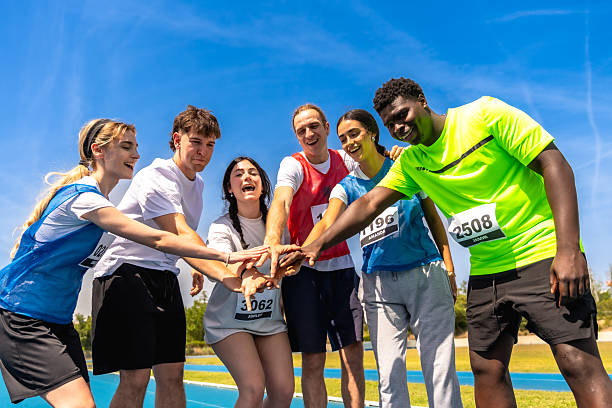 istock Young athletes joining hands before a race, showing their team spirit 2219738805