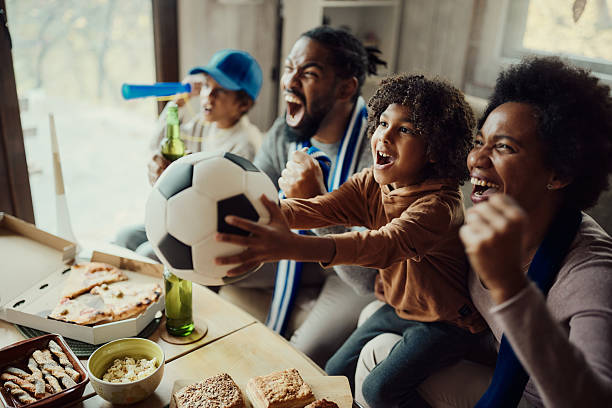 istock Cheering for favorite soccer team at home! 2219739013