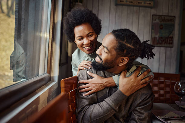 istock Happy black couple talking by the window at home. 2219739529
