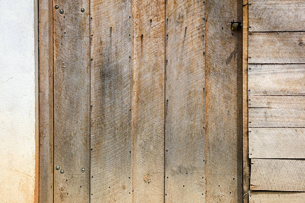A wooden door with a rusty lock