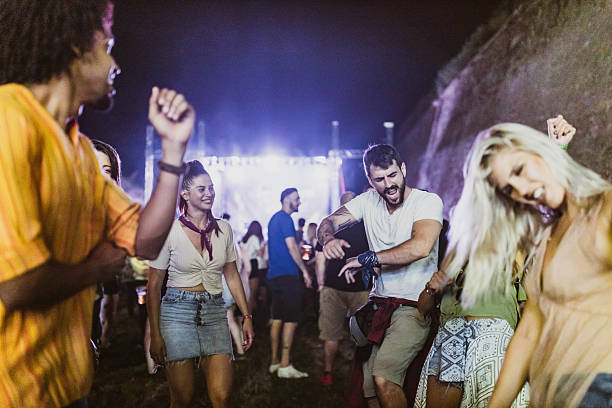 istock Group of cheerful people having fun while dancing on music concert by night. 2219742157