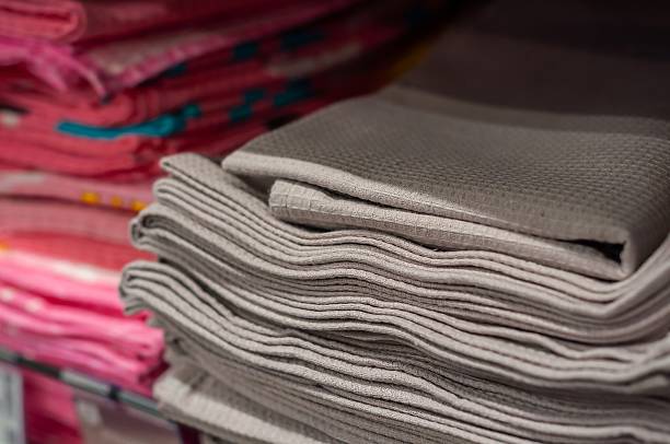 istock Neatly stacked gray and pink towels create a soft and inviting display in a retail setting. 2219742396