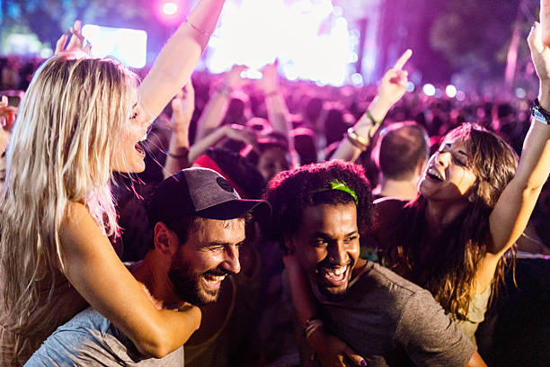 istock Carefree couples having fun while dancing on music festival. 2219742705