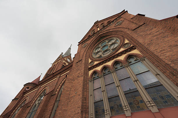 istock Catholic red brick church with a clock 2219744156