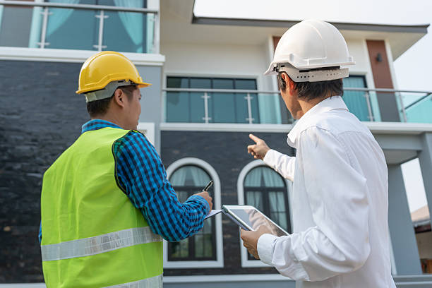 istock inspector engineer and owner project is inspecting construction and quality assurance new house. Engineers or architects or contactor work to build the house before handing it over to the homeowner 2219745363