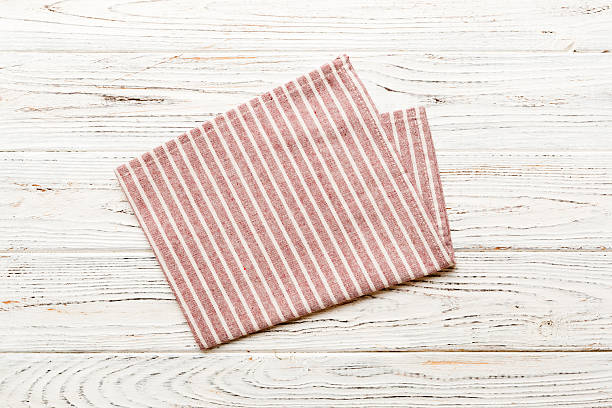 istock top view with red empty kitchen napkin isolated on table background. Folded cloth for mockup with copy space, Flat lay. Minimal style 2219745578