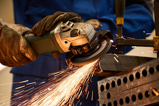 istock Industrial Worker Grinding Metal With Sparks Flying in Workshop 2219745956