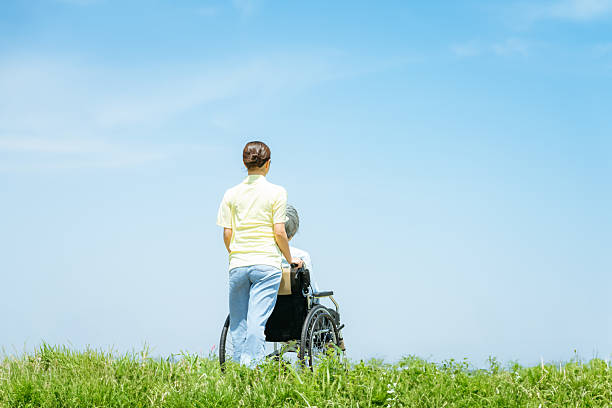 Caregiver pushing a wheelchair