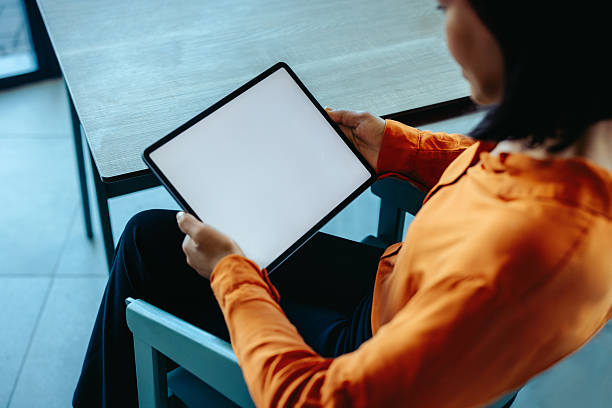 istock Businesswoman using a tablet in modern office setting 2219751187