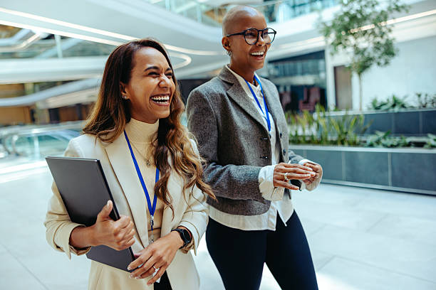 istock Two female professionals walking in modern corporate setting 2219751317