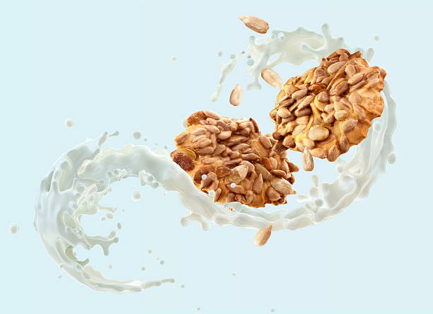 istock Granola clusters, milk splash, light blue background. 2219752940