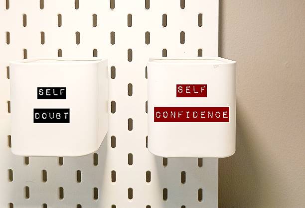 Two boxes with text label SELF DOUBT and SELF CONFIDENCE - to overcome self-doubt (feelings of uncertainty and questioning one's abilities) to self-confidence by focus on building self-belief and self-acceptance