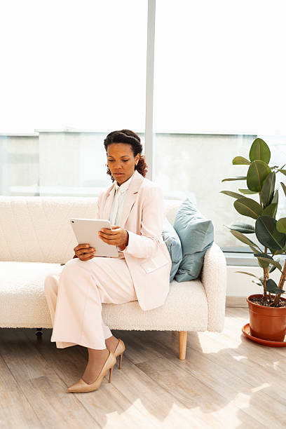 istock Professional woman in a modern office space using a tablet 2219757209