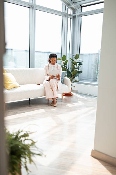 istock Professional woman using a tablet in a modern bright workspace 2219757212