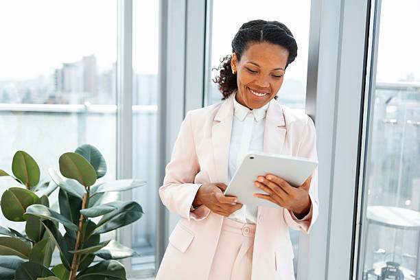 istock Professional woman in modern office using a digital tablet for work 2219757215