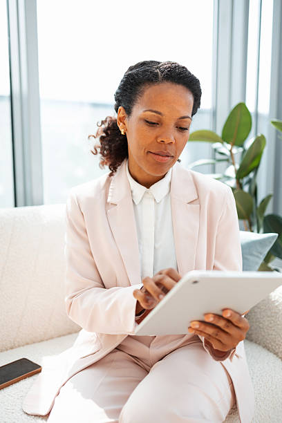istock Professional businesswoman using a tablet in a modern office environment 2219757217