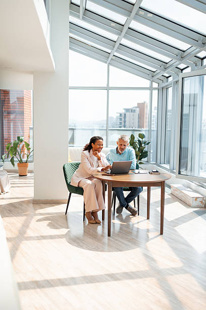 istock Business professionals collaborating in a modern bright office with a laptop 2219757304