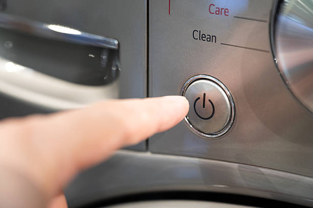 istock Finger Pressing Power Button on Modern Appliance. 2219758629