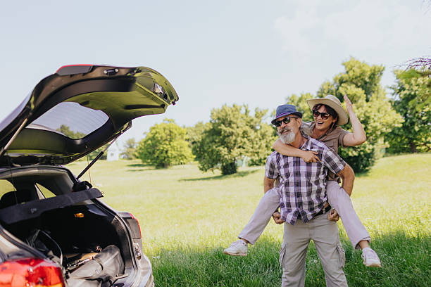 istock Playful middle aged couple having fun during piggyback ride in green spring nature 2219763294