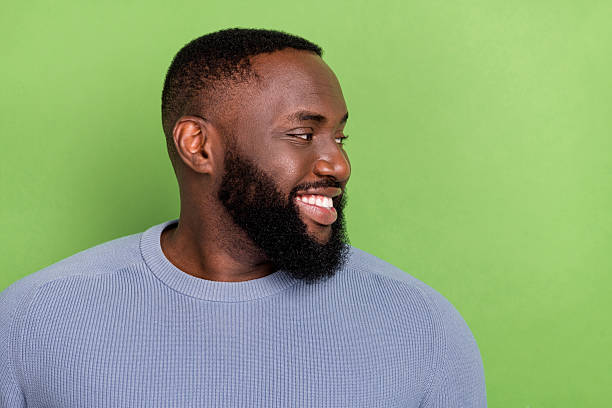 istock Photo of positive afro guy wear grey pullover looking empty space smiling isolated green color background 2219763789