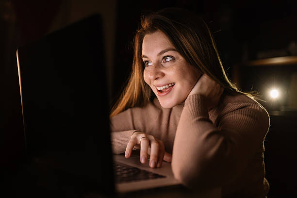 istock Euphoric and surprised woman winning online, watching a laptop a 2219765611