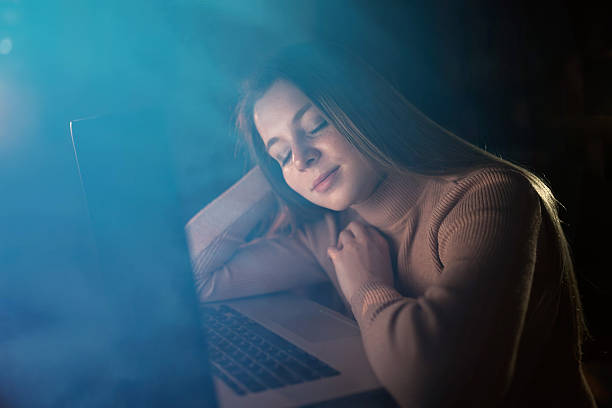 istock woman sleep on computer working, tired at night in dark room lig 2219765622
